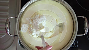 The cook boils the cottage cheese, beats, adds raisins and nuts, stirring the curd mass. Knead the curd dough in a white