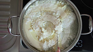 The cook boils the cottage cheese, beats, adds raisins and nuts, stirring the curd mass. Knead the curd dough in a white