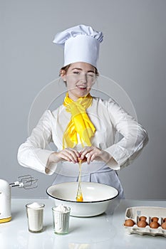 Cook breaking egg