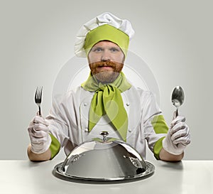 Cook chef with fork, spoon and food tray on isolated background