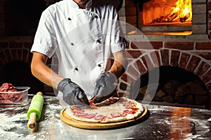 Cook Chef making delicious pizza at the restaurant, close-up