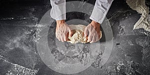 Cook or chef preparing dough for pizza bases