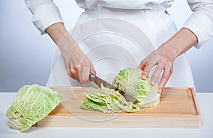Cook chopping savoy cabbage
