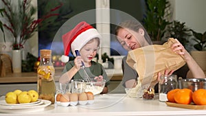 Cook on Christmas Eve. Mom, daughter preparing breakfast New Year holiday. Weekend breakfast in kitchen at table