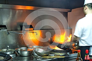 The cook in the crowded kitchen work