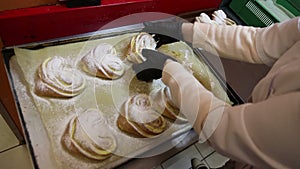 Cook in the culinary shop makes dough rolls pies and pretzels