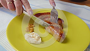 cook cuts hot homemade grilled sausage. the process of making homemade grilled sausage from minced meat.