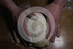 The cook from the dough begins to make baking dishes