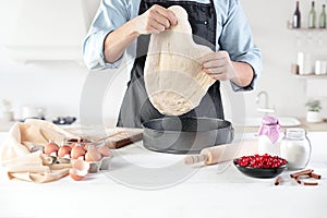 A cook with eggs on a rustic kitchen against the background of men`s hands