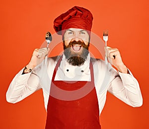 Cook with excited face in burgundy hat and apron