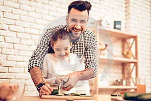 Cook Food at Home. Happy Family. Father`s Day. Girl and Man Cook Food. Man and Child at Table. Spend Time Together. Grate Cheese.