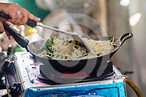 The cook is fried noodles is one food for their ancestors and trader.