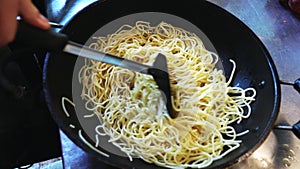 Cook Frying Spaghetti in Wok