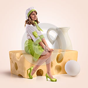 Cook girl sitting on a piece of cheese