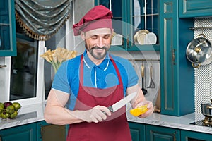 Cook going cut Yellow bell pepper. Chef man cooking vegetables in the kitchen. Man start cutting orange paprika.