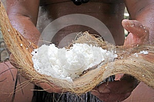 Cook Islander man holds desiccated coconut fruit in Rarotonga Co