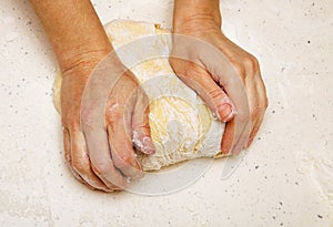 Cook kneads dough for bread