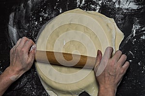 Cook kneads dough on dumplings with minced meat on a special form