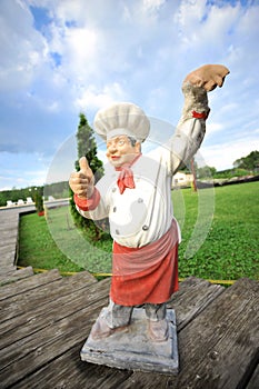 A cook made in ceramic in a garden
