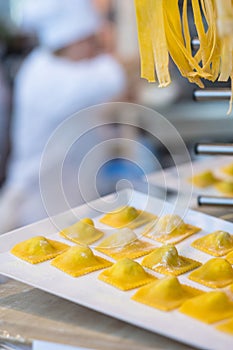 Cook making fresh ravioli and pasta