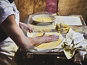 Cook making Tortillas on a wooden rustic table photo