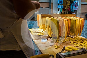 Cook making traditional Italian pasta on Via della Croce in Rome, Italy photo