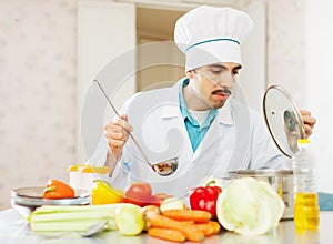 Cook man works at kitchen