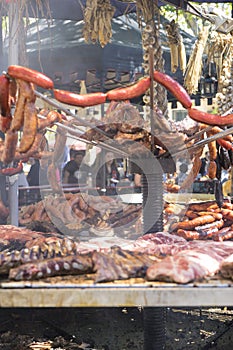 cook, medieval barbecue with sausages, octopus, meat, ribs and a