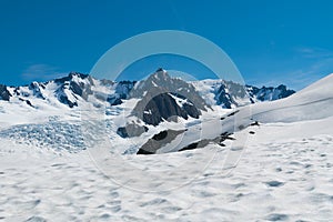 Cook Mount with snow landing and clear blue sky background