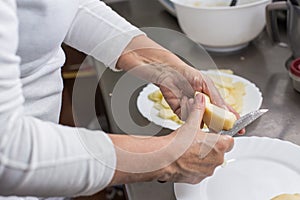 Cook peeling apples in the kitchen