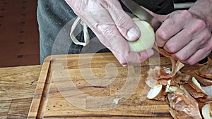 The cook peels the onions. Men's hands peeling onions. The concept of cooking, gastronomy and culinary. Footage from