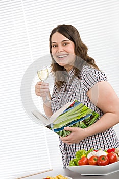 Cook - plus size happy woman holding cookbook