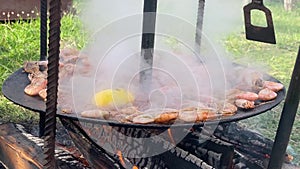 The cook pours shrimp on the grill with sauce. Close-up of king prawns frying in a frying pan. The chef is frying king