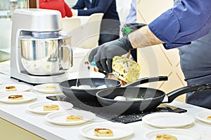 The cook pours sunflower oil for syrniki in frying pan