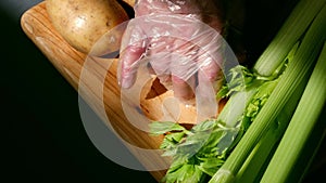 Cook prepares fresh vegetables ingredients prepared on chopping board