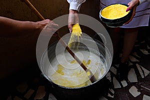 The cook prepares Mamaliga,  Romanian traditional food from Salaj photo