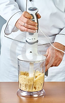 The cook puts in the blender ingredients for cooking stuffed fish full collection of culinary recipes