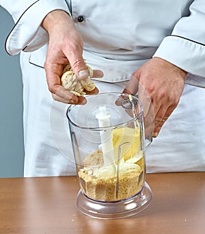 The cook puts in the blender ingredients for cooking stuffed fish full collection of culinary recipes