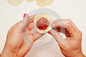 Cook puts minced meat on dough