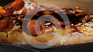 The cook puts pizza bread into burning stove. Frame. Pizza making closeup with green olives and peppers and cheese in