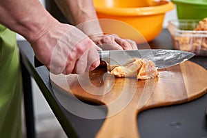 Cook removing skin from chicken wings