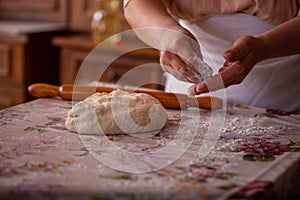 Cook's hands kneading dough for cakes. Preparing the flour for leavening