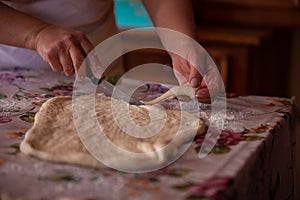 Cook's hands kneading dough for cakes. Preparing the flour for leavening