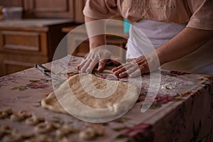 Cook's hands kneading dough for cakes. Preparing the flour for leavening