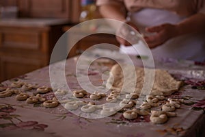 Cook's hands kneading dough for cakes. Preparing the flour for leavening