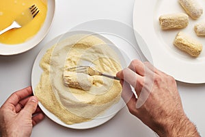 Cook's hands preparing croquettes