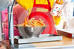 cook sells churros in a cafe on the street