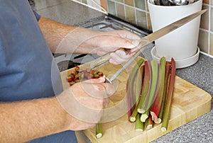 Cook sharpening knife over chopping board