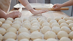 Cook sifts flour and sugar decorating pies in the bakery