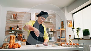 Cook sprinkling a piece of dough with flour